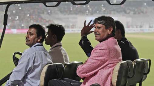 Former Indian cricketer Kapil Dev acknowledges the crowd