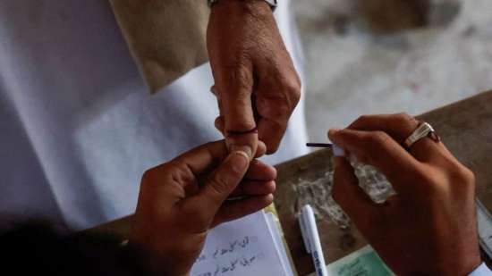 India Tv - A voter gets an ink mark on his thumb after castin