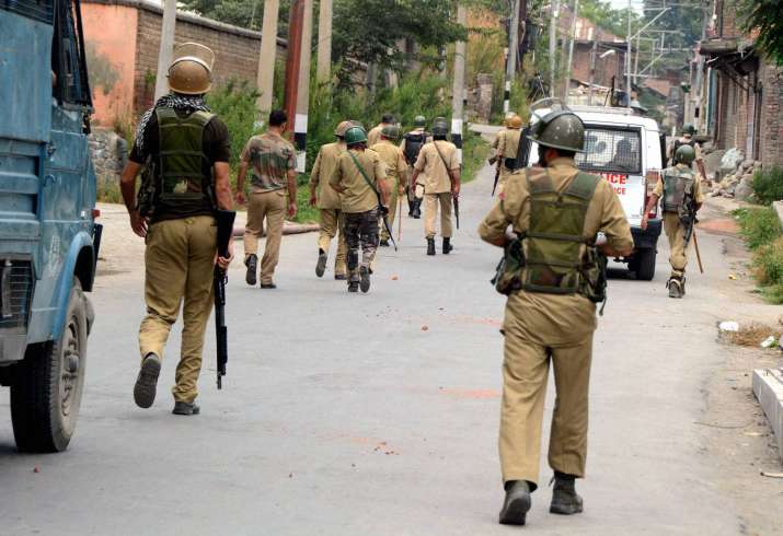 Security Jawans petrolling on a street in Srinagar during