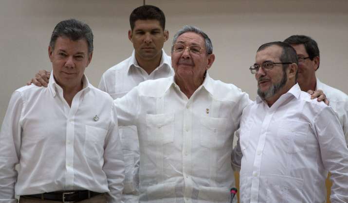 Cuba's President Raul Castro, center, stands with Colombian