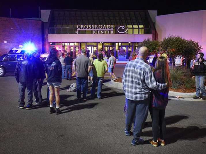 People stand near the entrance of Crossroads Center mall in