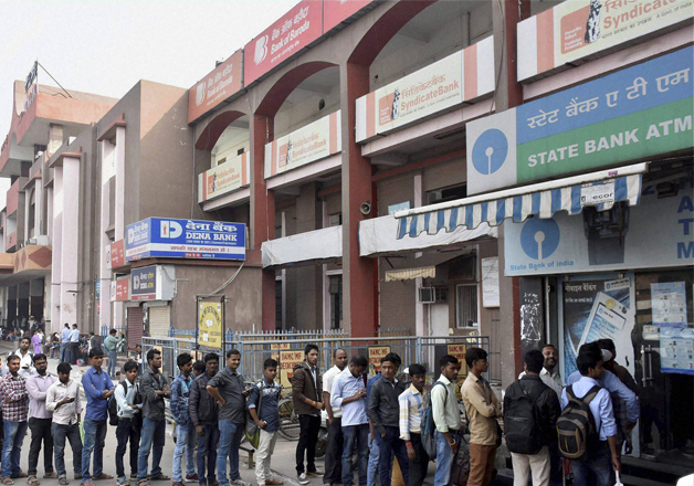 People stand in a long queue to withdraw money at an ATM in