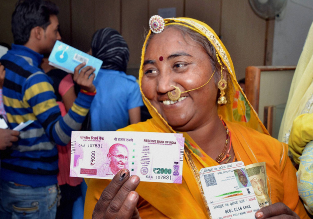 A rural woman senior citizen after exchanging Rs 500 and