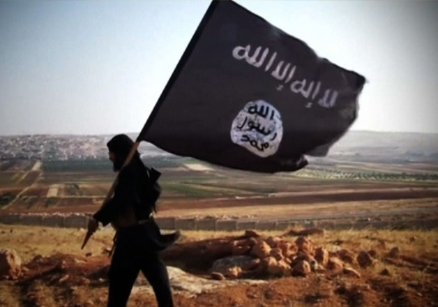 File pic - ISIS militant waves terror outfit's flag