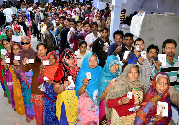 People stand in queue to cast their vote in Agra