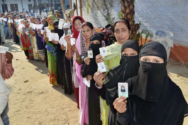 Women line up at a polling booth in Varanasi during final