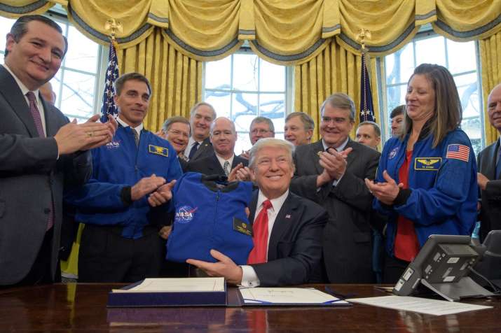 Trump signs NASA funding bill, sets goal of human on Mars