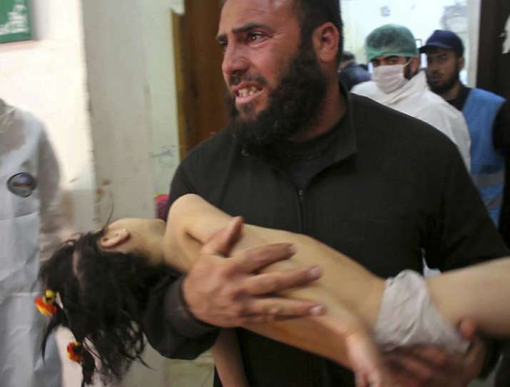 A man carrying a child following a suspected chemical
