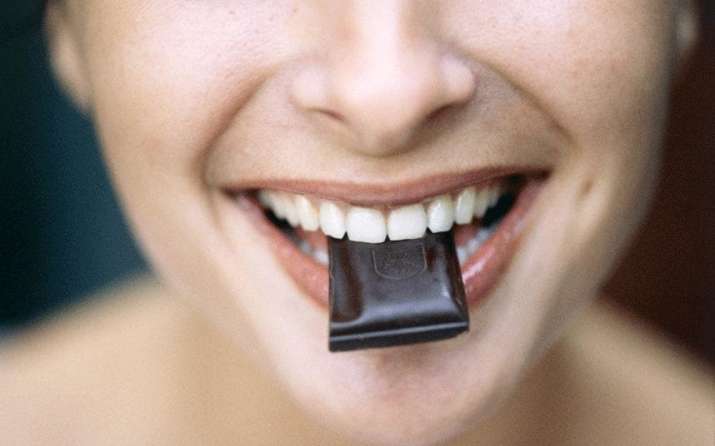 woman eating dark chocolate xlarge 1491371447