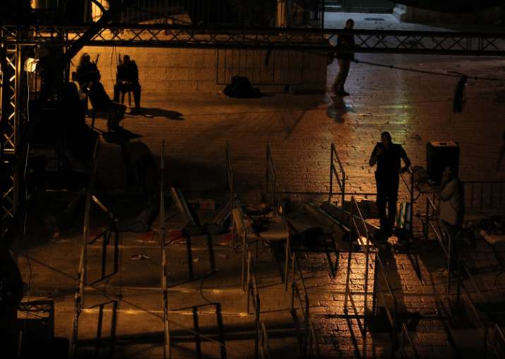 Workers dismantle metal detectors outside the al-Aqsa