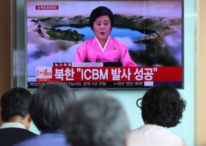 People watch a live TV report at Seoul Station on July 4