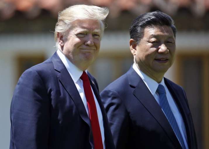 File pic - Trump and Jinping walk together after their