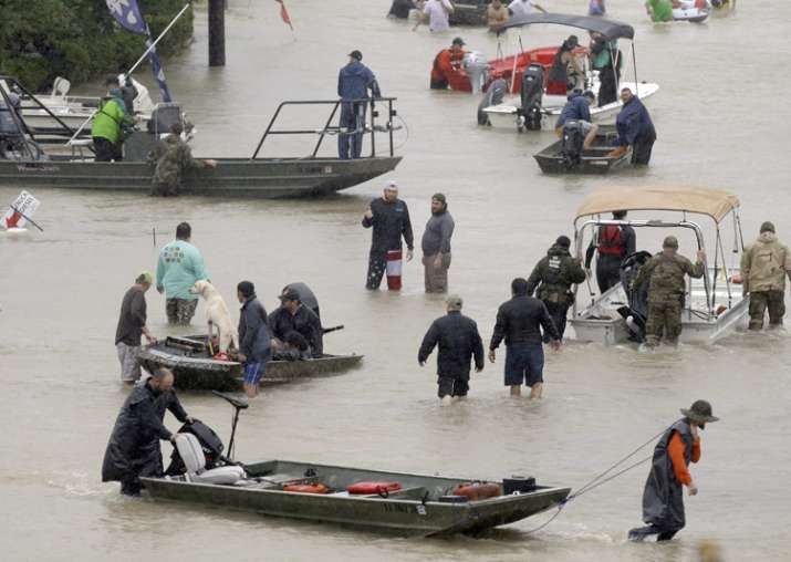 People and rescue boats line a street at the east Sam