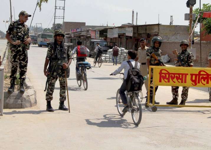 Security forces stand guard at Satnam Chowk, the main