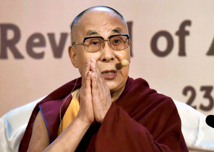 Dalai Lama gestures during an interactive session at a city