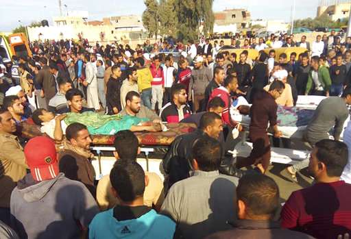 Injured people are evacuated from the scene of a militant