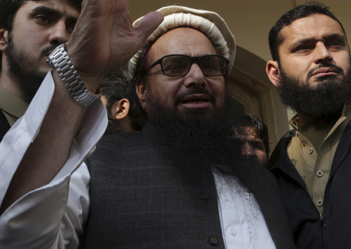 Hafiz Saeed waves to his supporters at a mosque in Lahore