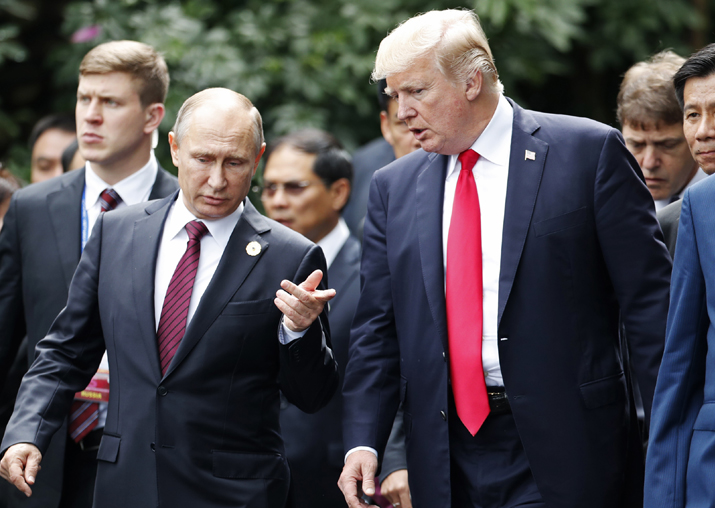 Donald Trump and Vladimir Putin talk during the family