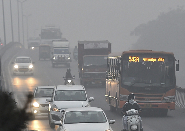 File pic - Vehicles plying at a road in smog in New Delhi