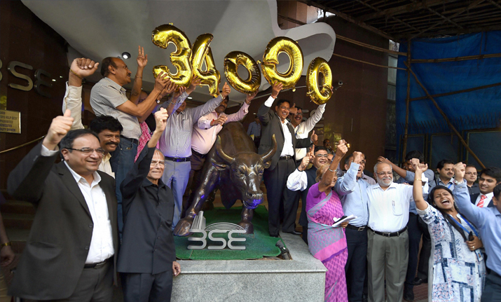Brokers and BSE management celebrate as the Sensex crossed