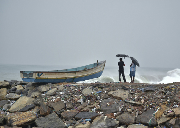 File pic - Two men hold umbrellas to protect themselves