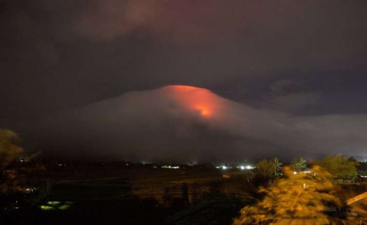 Orange glow seen at the cloud-shrouded crater of Mayon