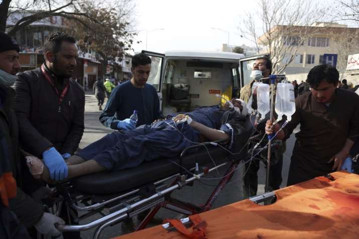 An injured man is moved on a stretcher outside a hospital