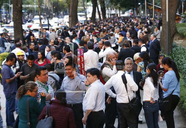People stand along Reforma Avenue after a 7.2-magnitude