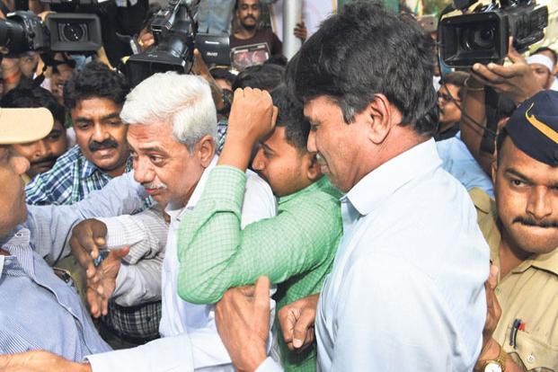 CBI officials escort Gokulnath Shetty (C, grey hair), the