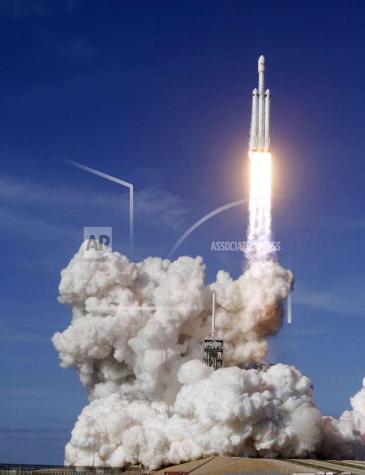 India Tv - A Falcon 9 SpaceX heavy rocket lifts off from pad 39A at the Kennedy Space Center in Cape Canaveral, Fla., Tuesday, Feb. 6, 2018. The Falcon Heavy, has three first-stage boosters, strapped together with 27 engines in all. (Red Huber/Orlando Sentinel via AP)