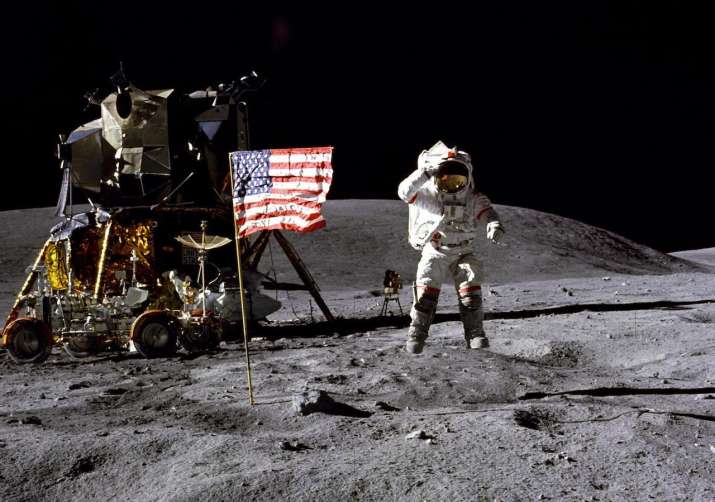 Astronaut leaping on lunar surface near landing vehicle and