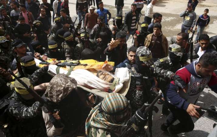 Fateh masked militants carry the body of Hamdan Abu Amsha,