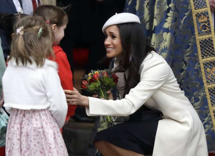 India Tv - Meghan Markle received flowers as she left after attending the Commonwealth Service at Westminster Abbey in London on March 12.