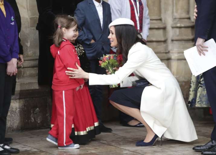 India Tv - Meghan Markle talking to children while leaving Commonwealth Service at Westminster Abbey in London on March 12