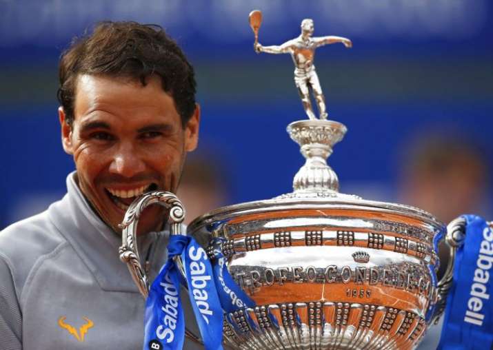 Rafael Nadal poses with his trophy after winning the