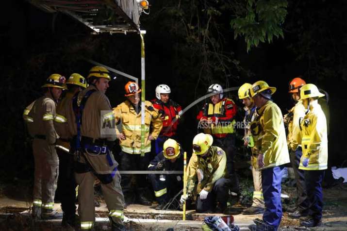 Firefighters search for a 13-year-old boy in a hole near