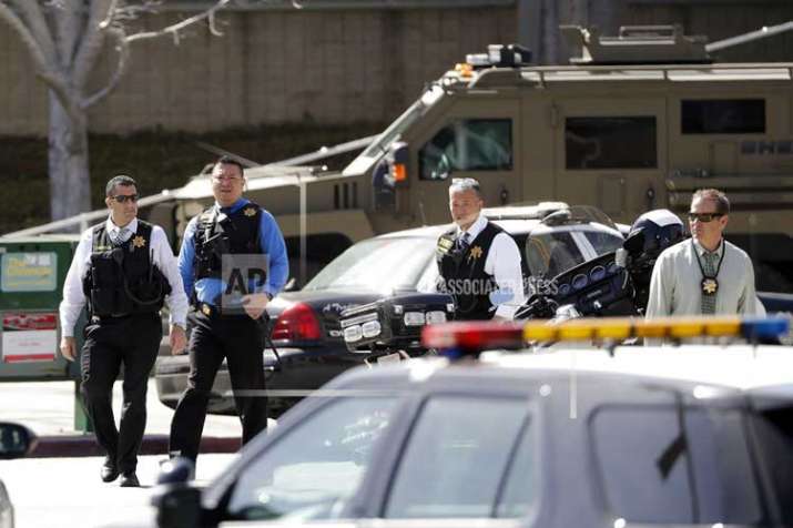 Armed law enforcement personnel exit YouTube headquarters,