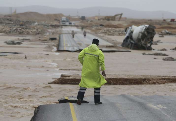 India Tv - An Omani civil defence staff visits a road which has been cut by the flood water after Cyclone Merkunu in Salalah on Saturday. India Tv - An Omani civil defence staff visits a road which has been cut by the flood water after Cyclone Merkunu in Salalah on Saturday.