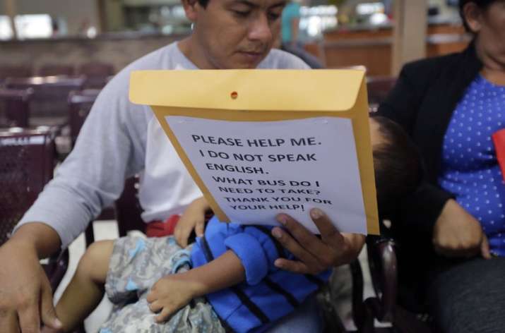 Immigrants from Guatemala seeking asylum look over travel