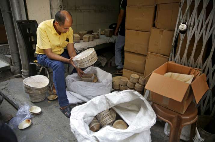 India Tv - Sanjay Aggarwal inspects the products he purchased from Prakritii, or nature, a company that manufactures eco-friendly dinnerware at the company's warehouse in New Delhi.