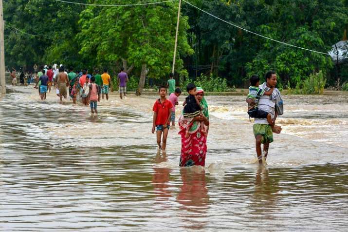 People shift to safer places from a flooded locality after