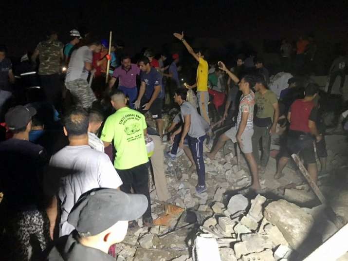 People look for for missing victims after explosions in