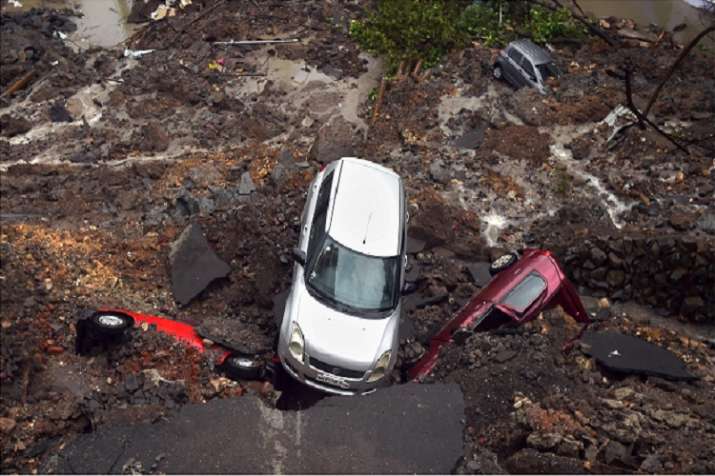 India Tv - Several cars struck in debris after a wall collapsed at a construction site in Antop Hill, Wadala East area, in Mumbai on Monday.