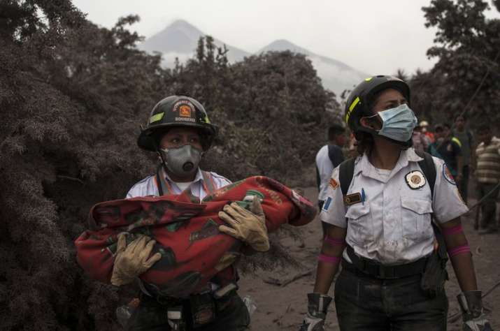 A firefighter carries the body of a child recovered near