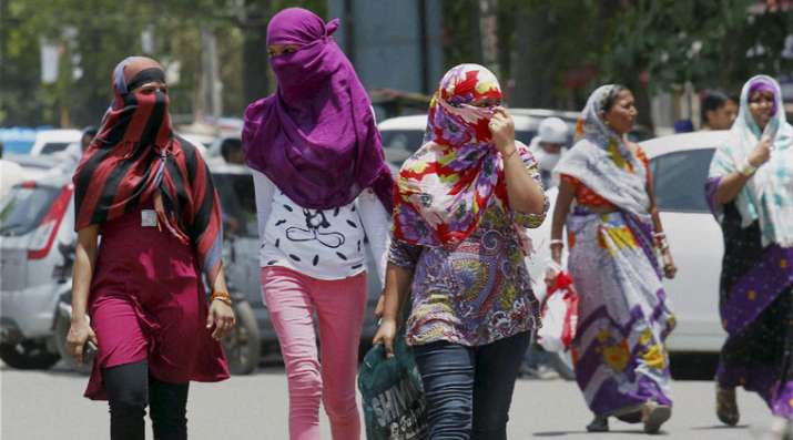 Allahabad: Girls cover their faces to beat the heat on a
