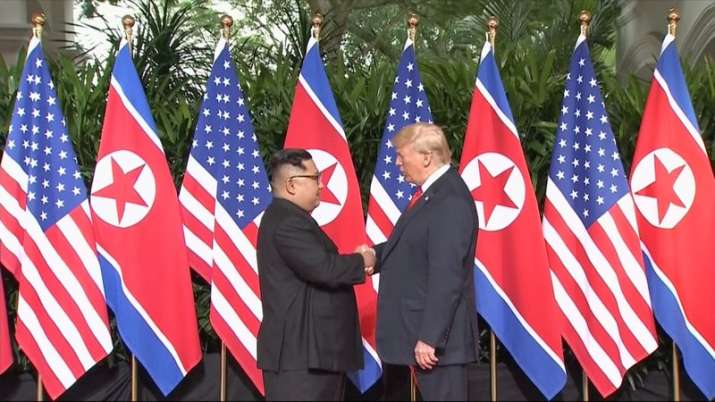 India Tv - In this image made from video provided by Host Broadcaster Mediacorp Pte Ltd, US President Donald Trump and North Korean leader Kim Jong Un shake hands ahead of their meeting at Capella Hotel in Singapore, Tuesday, June 12, 2018.