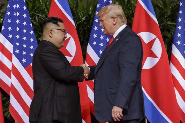 India Tv - US President Donald Trump shakes hands with North Korea leader Kim Jong Un at the Capella resort on Sentosa Island on Tuesday