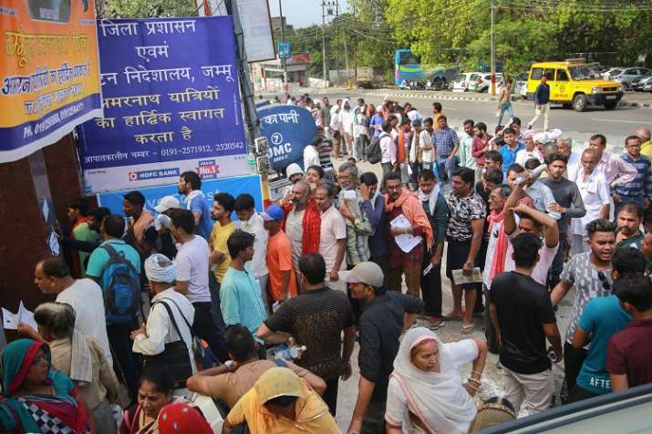 Pilgrims wait in a queue to get themselves registered for