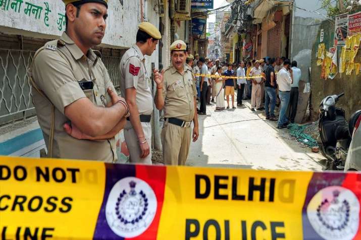 Police near the house, where 11 members of a family were