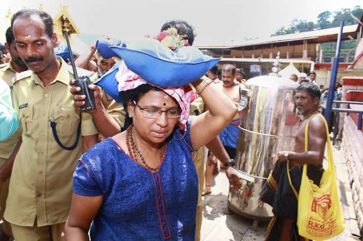 India Tv - A female devotee who had trekked up with her family to Sabarimala temple, in Pathanamthitta. Two women who reached the hilltop with heavy police escort, had to return before reaching the sanctum sanctorum following protests by Lord Ayyappa devotees.